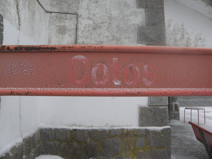 Cartel de la estaci�n semitapado por la nieve y el hielo